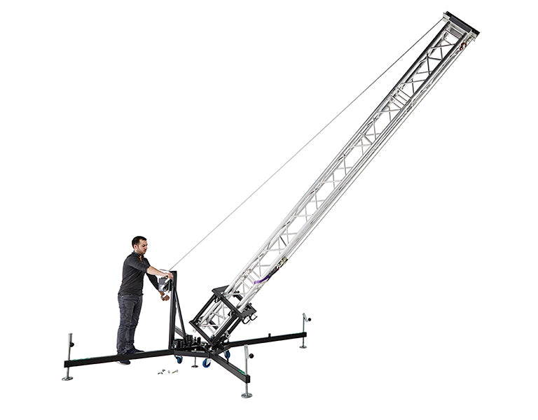 A single operator safely tilting the Kuzar K-10 tower lift from a horizontal position into a vertical setup using the integrated manual steel-cable winch system. - imagen 4