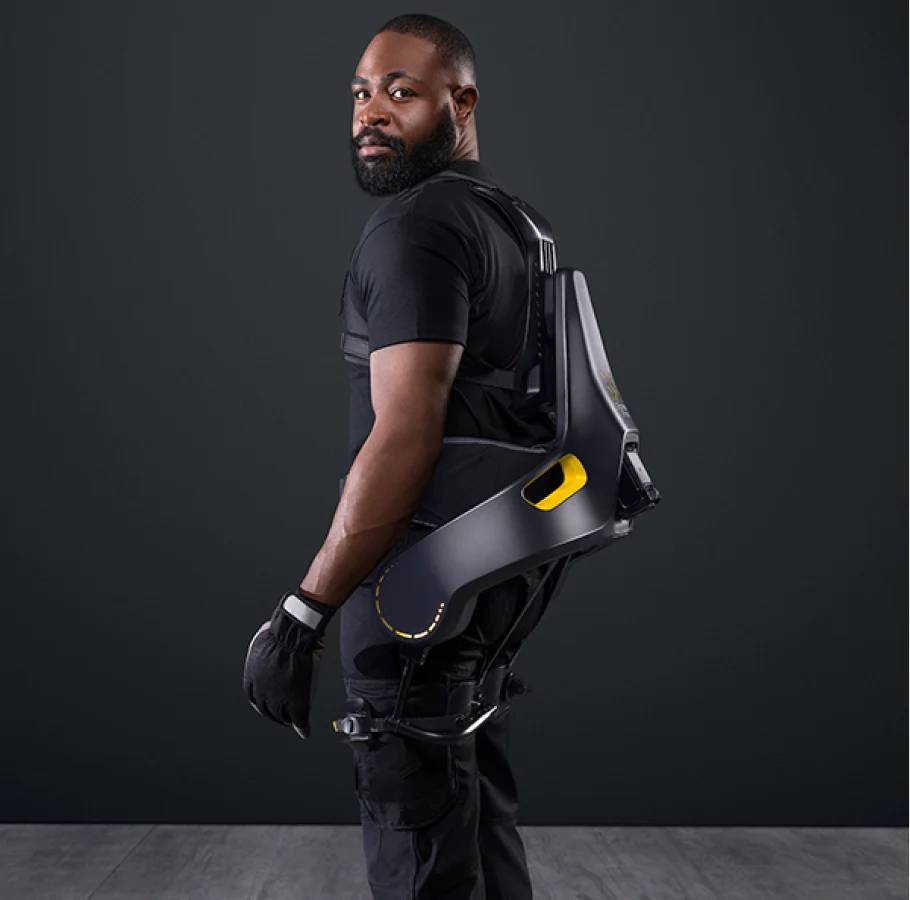 A man wearing the German Bionic Apogee exoskeleton, standing in a side profile pose, showcasing the structure and fit of the exoskeleton. – Now available at MTN Shop EU.