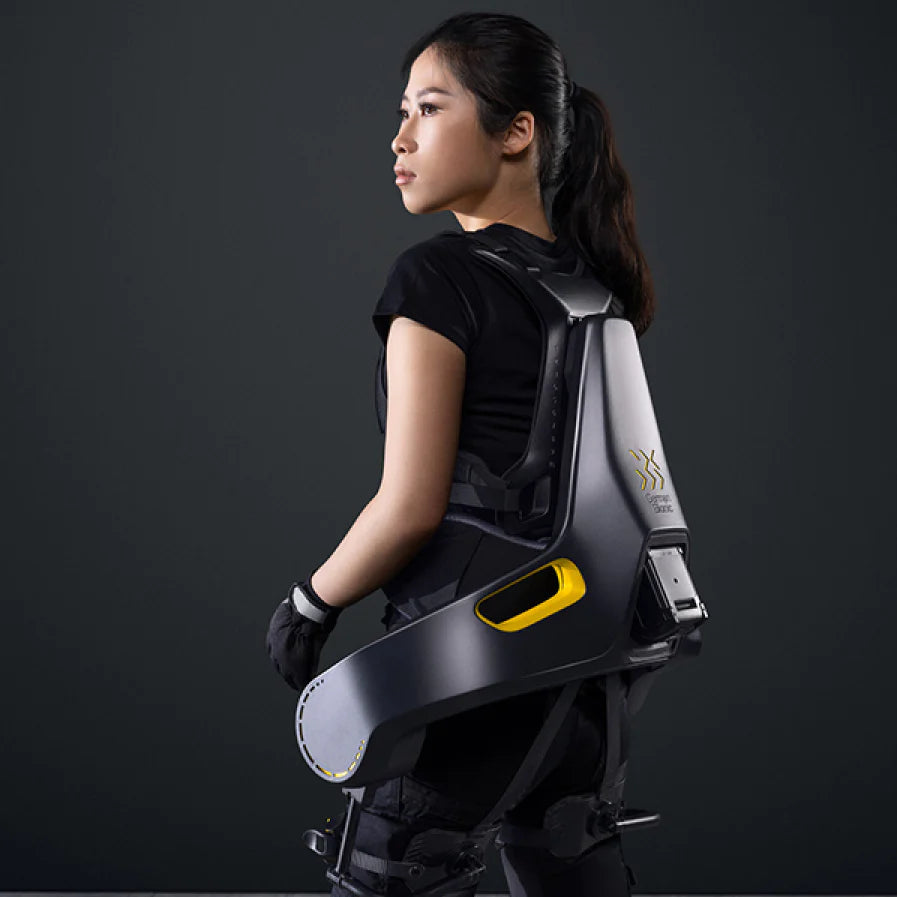 A woman wearing the German Bionic Apogee exoskeleton, looking over her shoulder, showcasing the sleek design and ergonomic fit of the wearable tool. – Now available at MTN Shop EU.