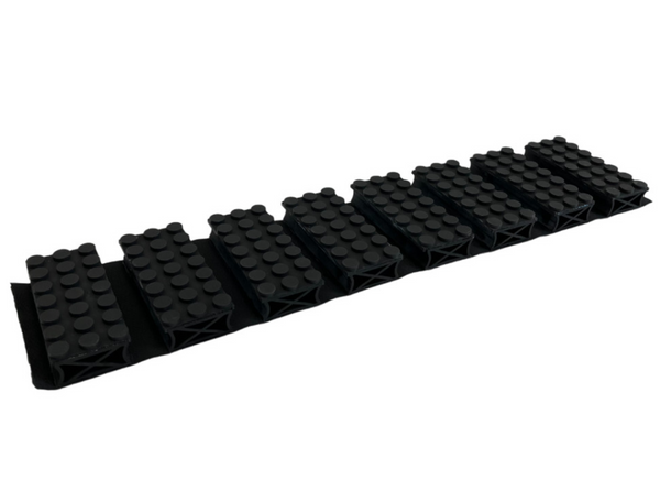 Tappetino in plastica nera con scanalature multiple su sfondo bianco