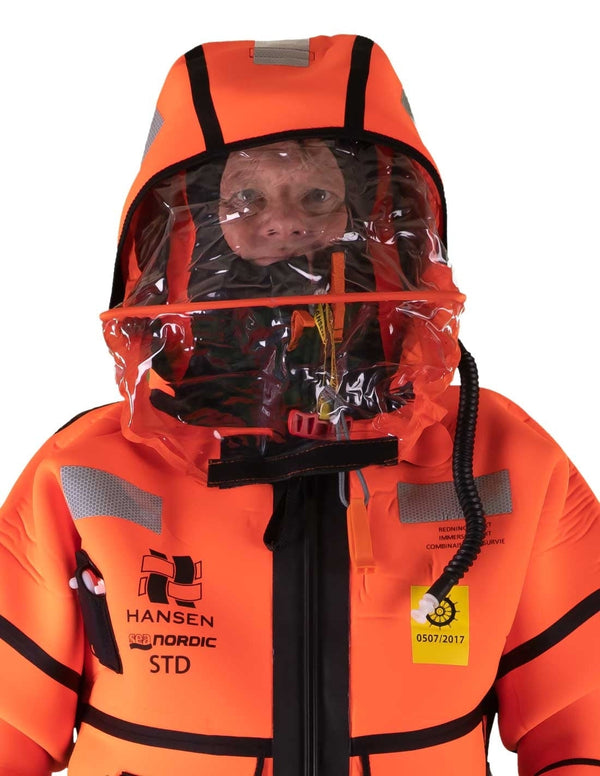 Hansen Protection SeaNordic Wet Suit 82606– A 6-hour immersion suit produced in extra strong flame-retardant neoprene. SeaNordic is equipped with an emergency light and has an integrated sprayhood that protects the face from waves and possibly seabirds. The hood has an innovative inflatable bladder for improved water tightness of the face seals, improved floatation and freeboard. The suit is certified for use without a lifejacket and is perfect as a survival suit on board fishing vessels, merchant ships and