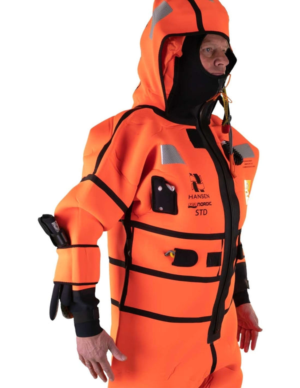 Hansen Protection SeaNordic Wet Suit 82606– A 6-hour immersion suit produced in extra strong flame-retardant neoprene. SeaNordic is equipped with an emergency light and has an integrated sprayhood that protects the face from waves and possibly seabirds. The hood has an innovative inflatable bladder for improved water tightness of the face seals, improved floatation and freeboard. The suit is certified for use without a lifejacket and is perfect as a survival suit on board fishing vessels, merchant ships and