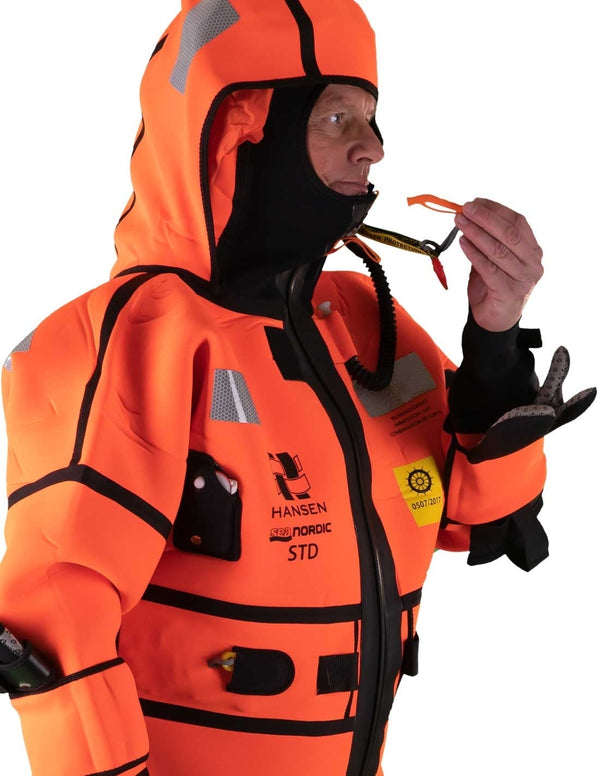 Hansen Protection SeaNordic Wet Suit 82606– A 6-hour immersion suit produced in extra strong flame-retardant neoprene. SeaNordic is equipped with an emergency light and has an integrated sprayhood that protects the face from waves and possibly seabirds. The hood has an innovative inflatable bladder for improved water tightness of the face seals, improved floatation and freeboard. The suit is certified for use without a lifejacket and is perfect as a survival suit on board fishing vessels, merchant ships and