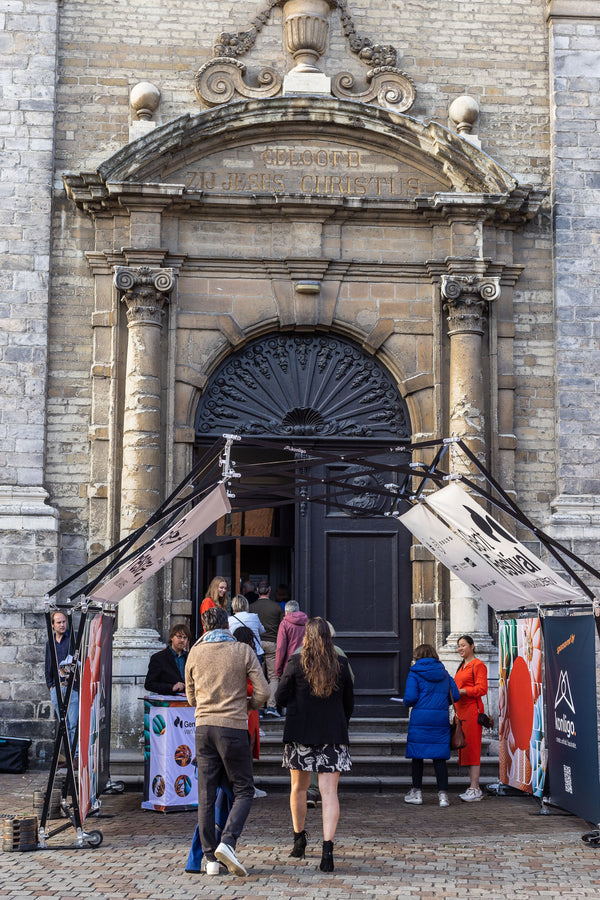 Konligo Arko470 foldable event structure with printed banners set up at the entrance of a historic building for a public event, now available on MTN SHOP US.