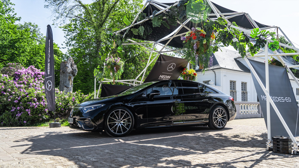 Konligo Fastival event structure with greenery and branding elements showcased at an outdoor car display, now available on MTN Shop US.