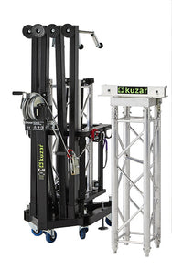 Compact folded view of the Kuzar K-10 tower lift base on swivel wheels next to a truss section, optimized for space-saving storage and European transport.