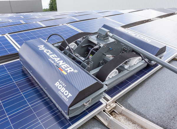 Solar panel cleaning robot on a solar panel
