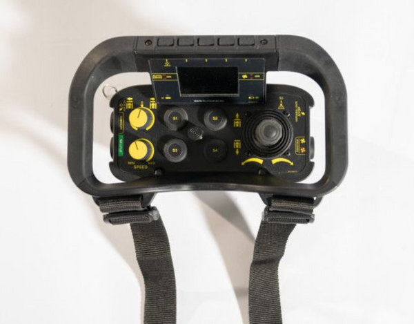 Black handheld device with control buttons and straps on a white background